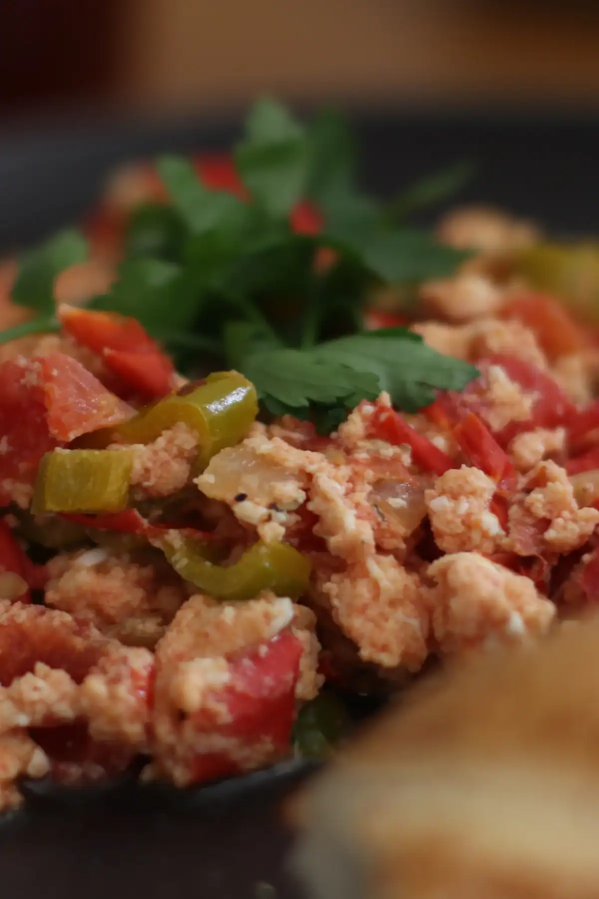 Traditional Turkish Menemen — scrambled eggs with tomatoes and peppers served hot with Simi